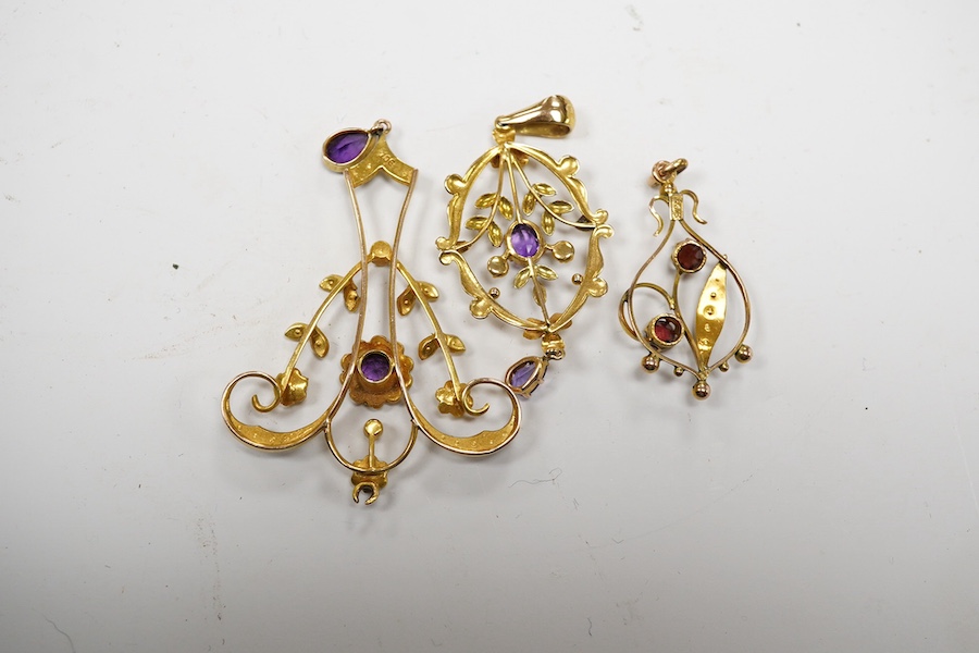 Three assorted early 20th century 9ct and gem set pendants, largest 53mm, gross weight 6.4 grams. Condition - poor to fair